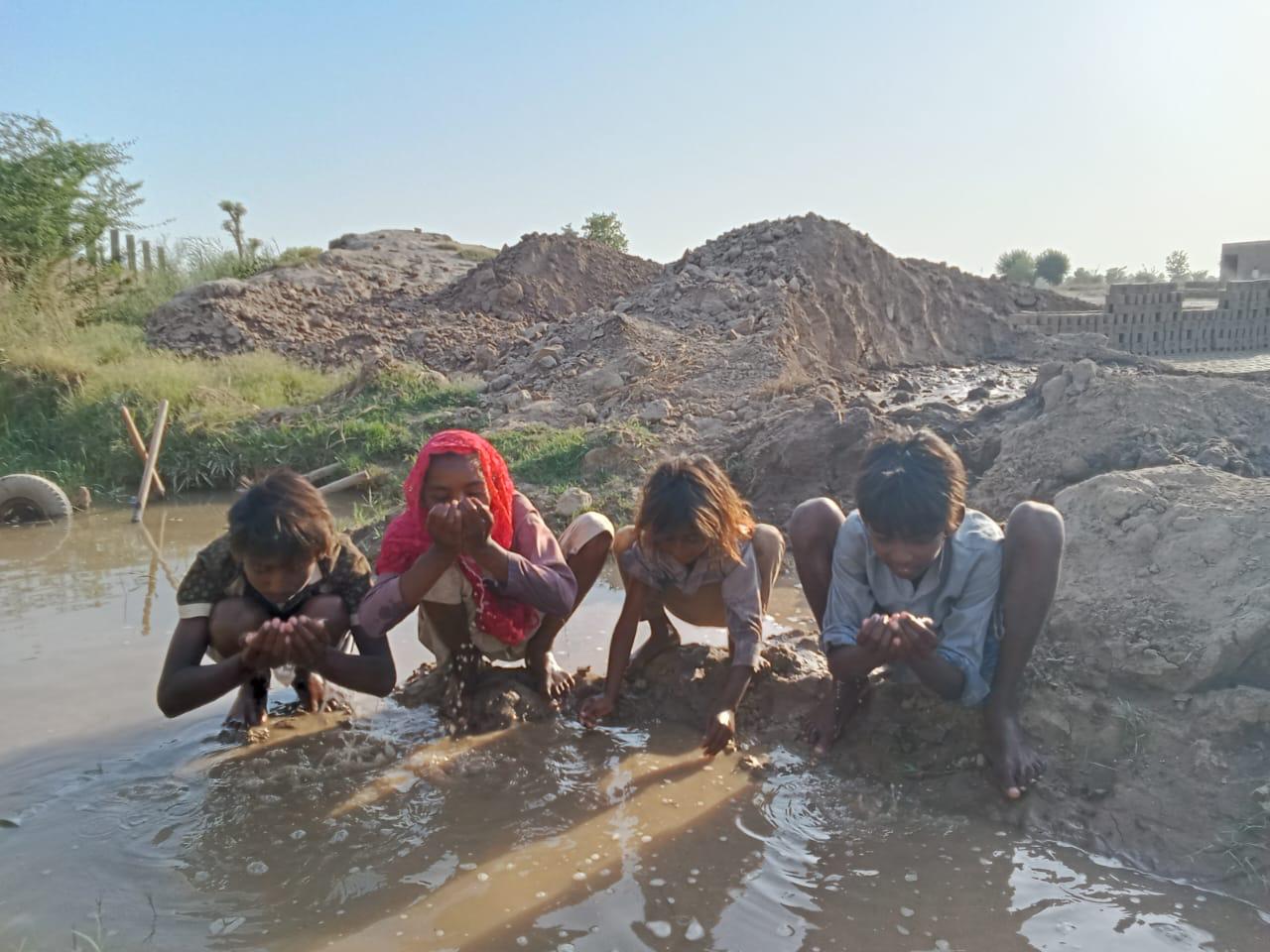 Children drinking dirty water — before Clean Water Life